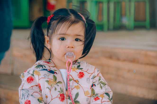 girl wearing white red and yellow floral top